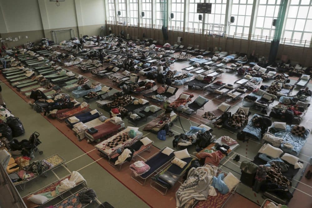 Hundreds of beds are placed inside a sports hall to accommodate Ukrainian refugees fleeing Russian invasion at the border crossing town of Medyka, Poland, on March 1, 2022. All day long, as trains and buses bring people fleeing Ukraine to the safety of Polish border towns, they carry not just Ukrainian fleeing a homeland under attack but large numbers of other citizens who had made Ukraine their home and whose fates too are now uncertain. (Visar Kryeziu/AP)