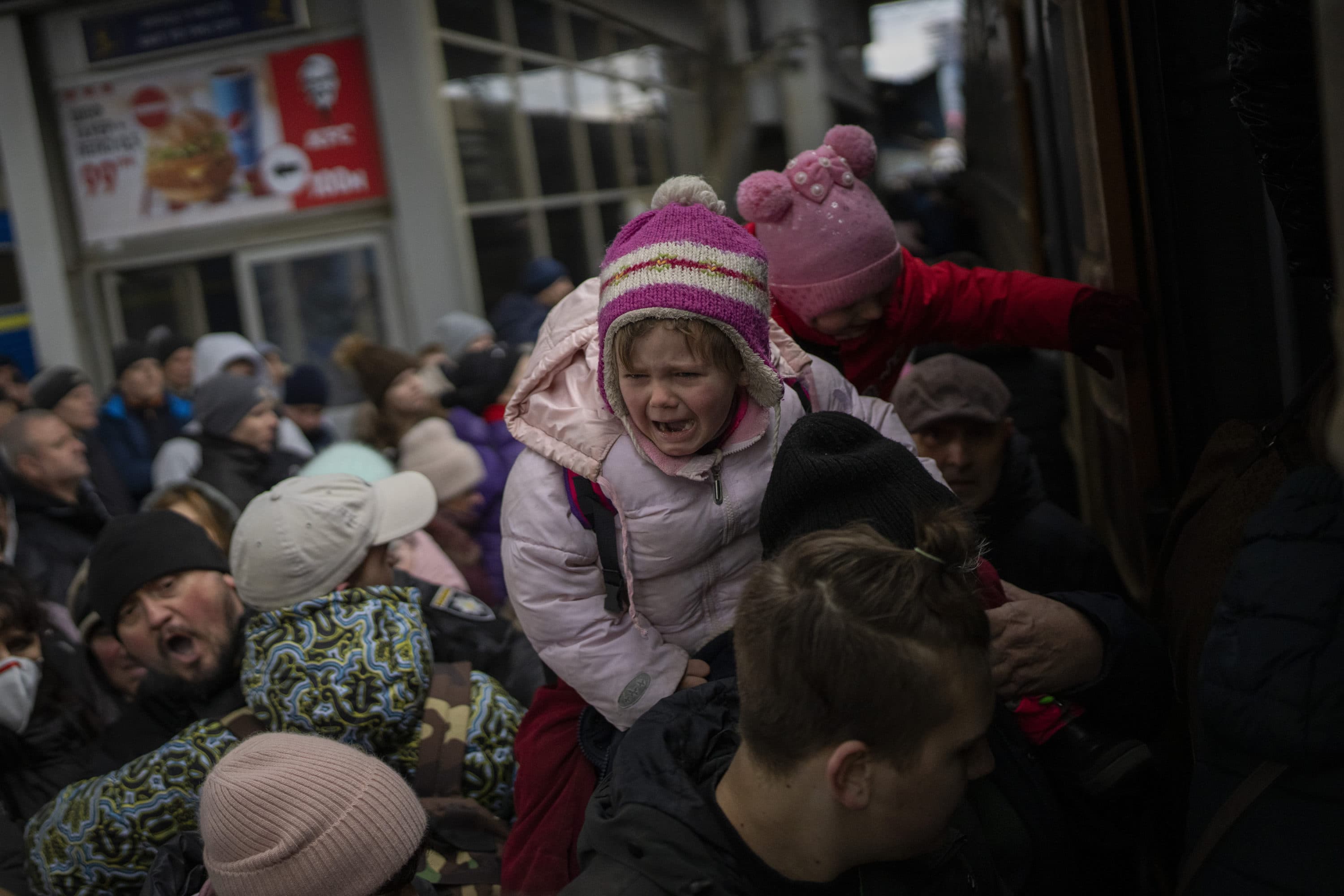 People holding their children struggle to get on a train to Lviv at the Kyiv station, Ukraine, Monday, March 7, 2022. (Emilio Morenatti/AP)