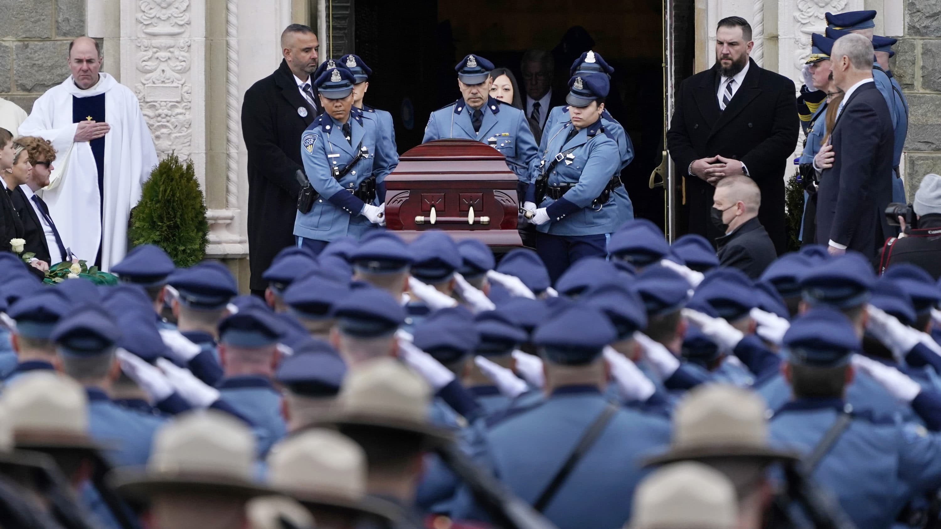 The casket of Massachusetts State Police Trooper Tamar Bucci is carried by female troopers from Saint Anthony of Padua church, March 9, 2022, in Revere, Mass. Bucci died last week after injuries she sustained when a tanker truck struck her cruiser while assisting a disabled vehicle on Interstate 93 North in Stoneham, Mass. (Charles Krupa/AP)
