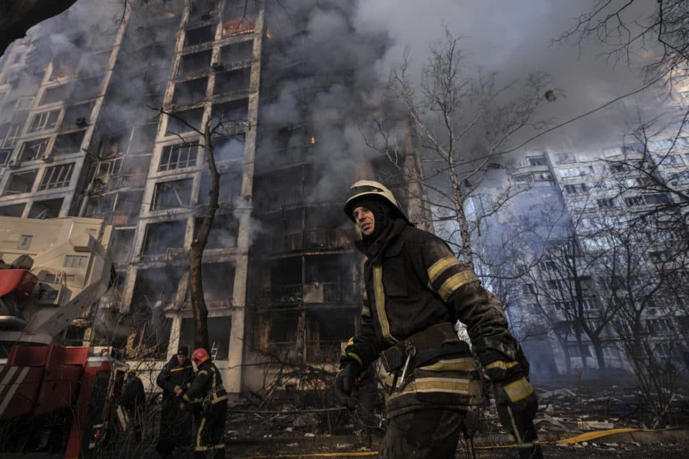 A firefighter walks outside a destroyed apartment building after a bombing in a residential area in Kyiv, Ukraine, Tuesday, March 15, 2022. (Vadim Ghirda/AP)