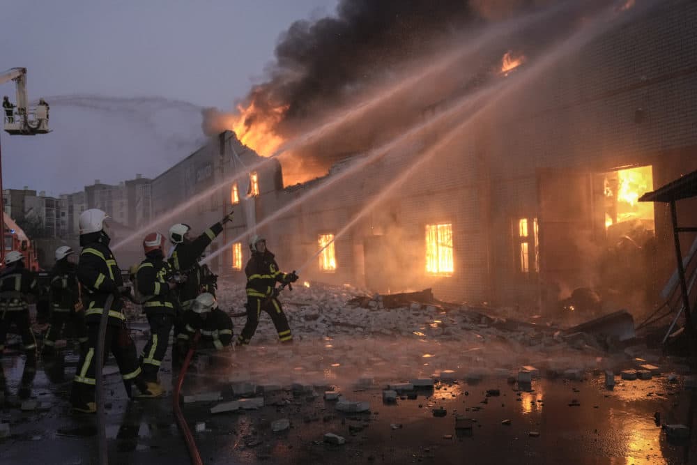 Ukrainian firefighters extinguish a blaze at a warehouse after a bombing in Kyiv, Ukraine, Thursday, March 17, 2022. Russian forces destroyed a theater in Mariupol where hundreds of people were sheltering Wednesday and rained fire on other cities, Ukrainian authorities said, even as the two sides projected optimism over efforts to negotiate an end to the fighting. (AP Photo/Vadim Ghirda)