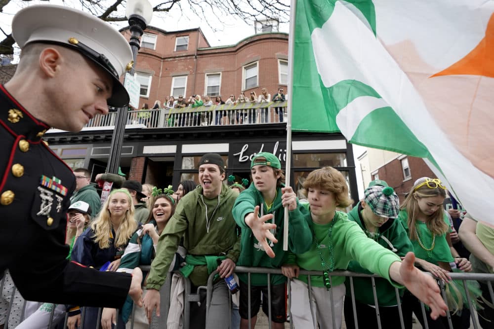A U.S. Marine greets spectators during the St. Patrick's Day parade on Sunday. (Steven Senne/AP)