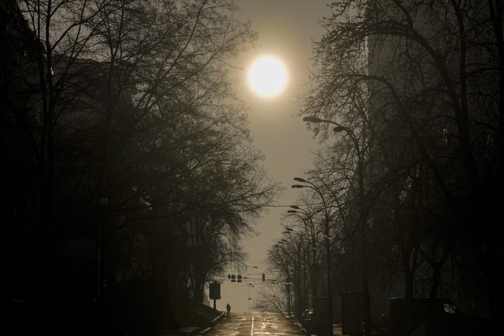 A woman walks on a deserted street in Kyiv, Ukraine, Monday, March 21, 2022. (Vadim Ghirda/AP)