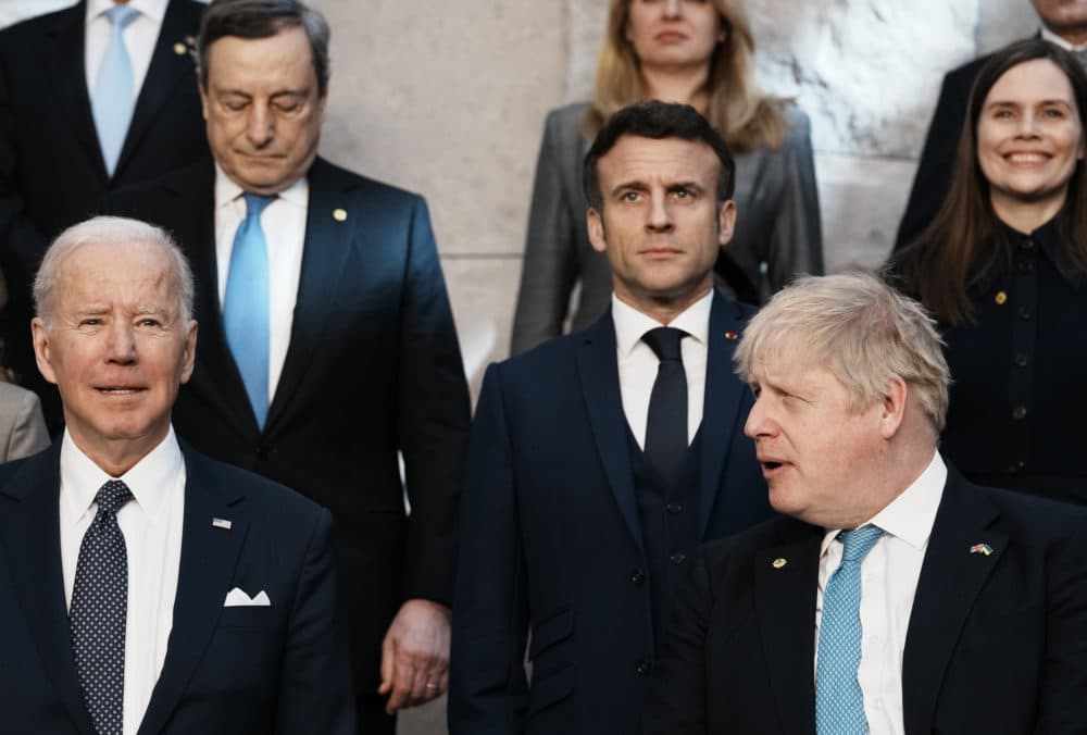 British Prime Minister Boris Johnson looks toward U.S. President Joe Biden at a group photo during an extraordinary NATO summit at NATO headquarters in Brussels on Thursday, March 24, 2022. (Thibault Camus/AP)