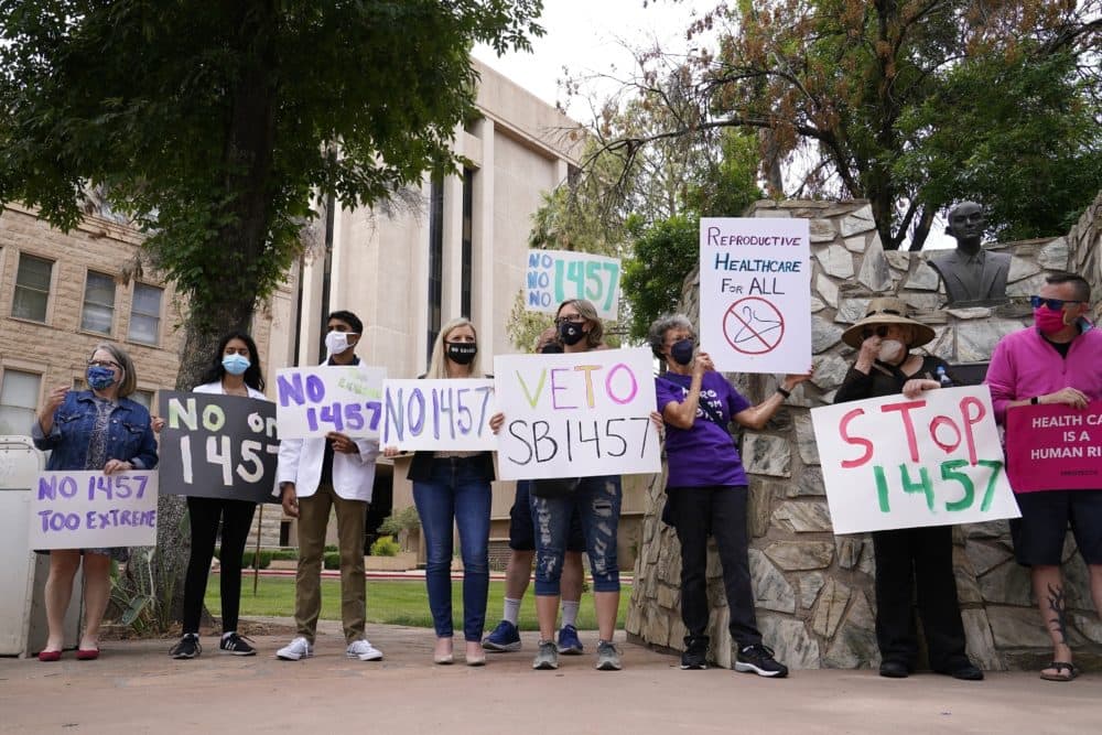 A number of Arizona reproductive health, rights, and justice advocates protest an abortion bill at the Arizona Capitol Monday, April 26, 2021, in Phoenix. (Ross D. Franklin, File)