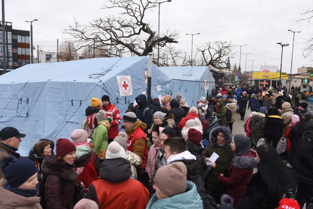 Evacuees gather by Red Cross tents set outside the railway station in western Ukrainian city of Lviv on March 2, 2022. (Yuriy Dyachyshyn/AFP via Getty Images)