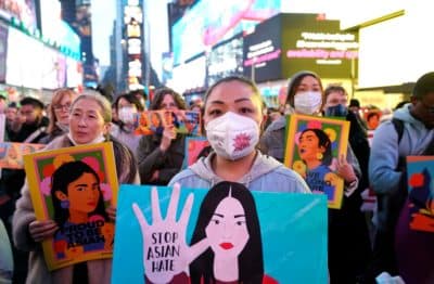 People rally calling for action and awareness on rising incidents of hate crime against Asian-Americans in Times Square in New York City on March 16, 2022. The rally is held on the 1st anniversary of the Atlanta Spa shootings. (Photo by Timothy A. Clary/AFP via Getty Images)