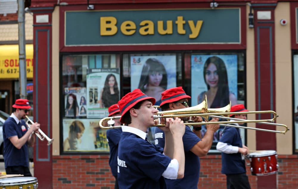 Members of the Tony Barrie Band pass by a beauty supply store on Dorchester Avenue during the Dorchester Day Parade, June 4, 2017. (Angela Rowlings/MediaNews Group/Boston Herald via Getty Images)