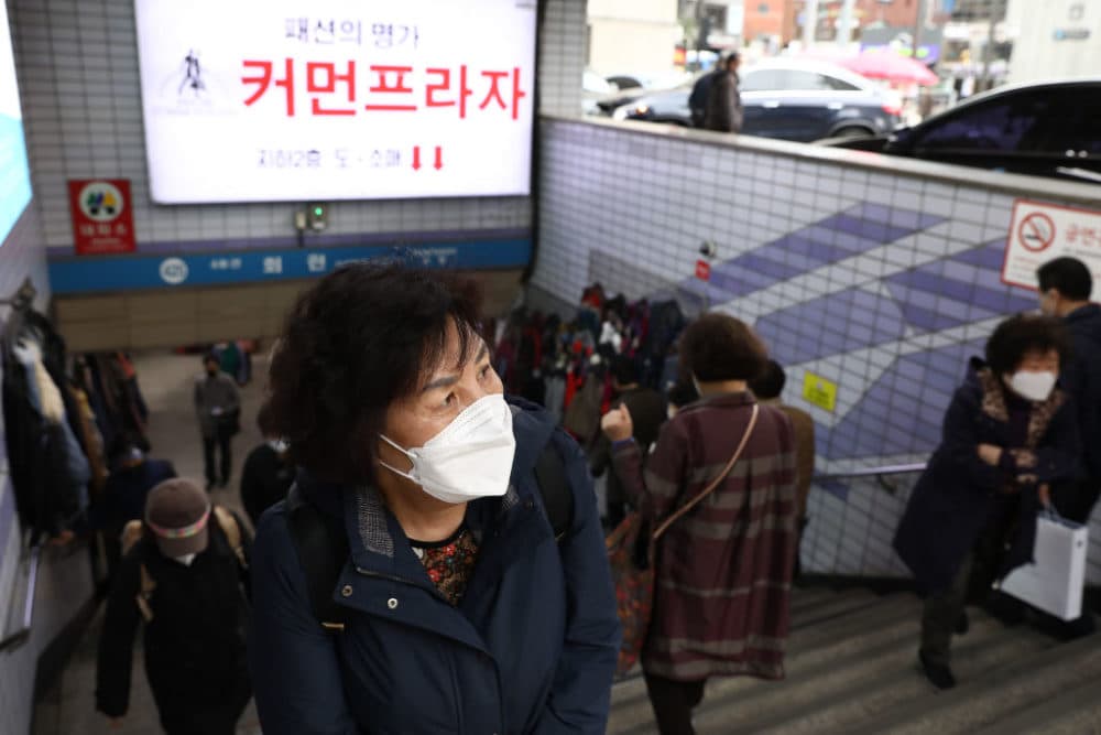 People walk along the Namdaemun market on March 17, 2022 in Seoul, South Korea.  (Chung Sung-Jun/Getty Images)