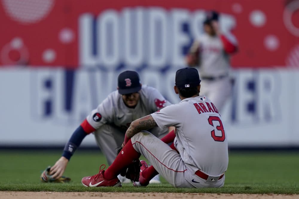 Boston Red Sox second baseman Jonathan Arauz (3) sits on the field after missing the walk-off single hit by New York Yankees' Josh Donaldson in the 11th inning of an opening day baseball game, Friday, April 8, 2022, in New York. (John Minchillo/AP)