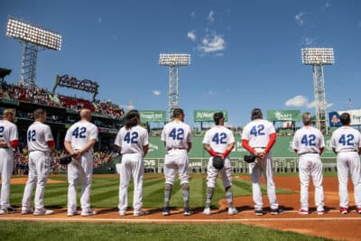 BOSTON, MA - APRIL 15: Members of the Boston Red Sox display the number 42 in recognition of Jackie Robinson Day as starting lineups are introduced before the 2022 Opening Day game against the Minnesota Twins on April 15, 2022 at Fenway Park in Boston, Massachusetts. (Photo by Billie Weiss/Boston Red Sox/Getty Images)