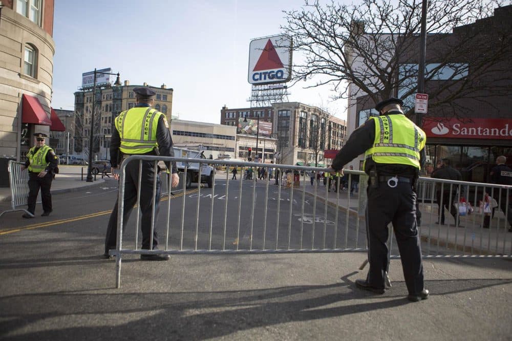 Police setting up a barricade on Brookline Avenue in Kenmore Square. (Jesse Costa/WBUR)