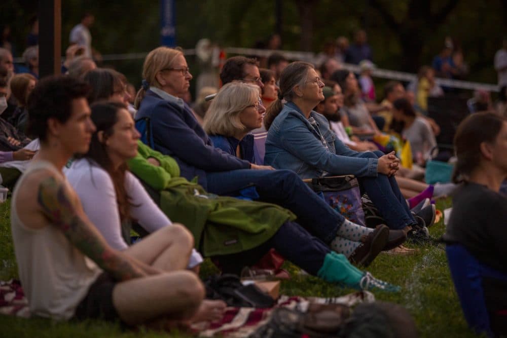 As darkness falls, people gather to watch &quot;The Tempest&quot; on Boston Common in 2021. (Robin Lubbock/WBUR)