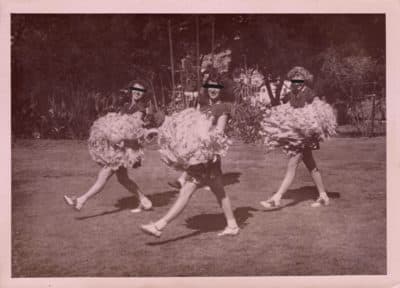 Three cheerleaders with black bars over their eyes. (Courtesy of clotho98 on Flickr. Edited by Michelle K. Martin)