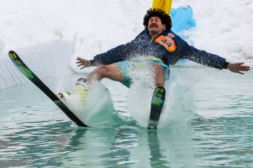 In northern Colorado, Steamboat Ski Resort's annual end-of-season pond skim returned this spring after a pandemic hiatus. “Rod Kimball” Matthew Kaplan winces just before his backside hits the pond. (Hart Van Denburg/CPR News)