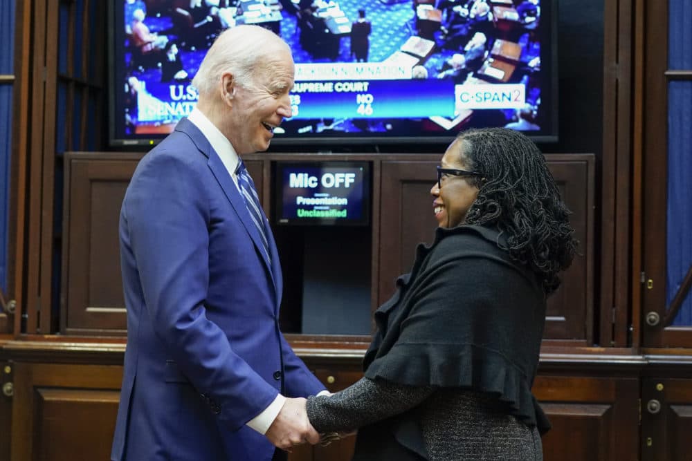 President Joe Biden holds hands with Supreme Court nominee Judge Ketanji Brown Jackson as they watch the Senate vote on her confirmation from the Roosevelt Room of the White House in Washington, Thursday, April 7, 2022. (Susan Walsh/AP)