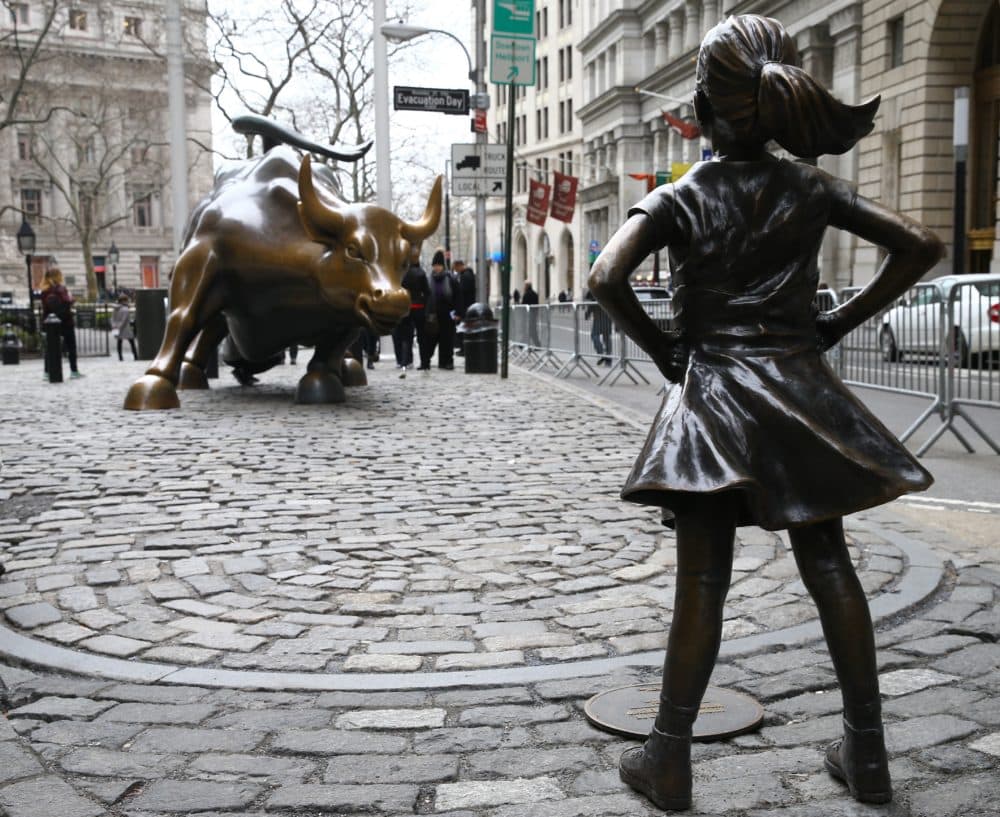 The &quot;Fearless Girl&quot; statue, a four-foot statue of a young girl, defiantly looks up the iconic Wall Street &quot;Charging Bull&quot; sculpture in New York City, United States on March 29, 2017. (Volkan Furuncu/Anadolu Agency/Getty Images)