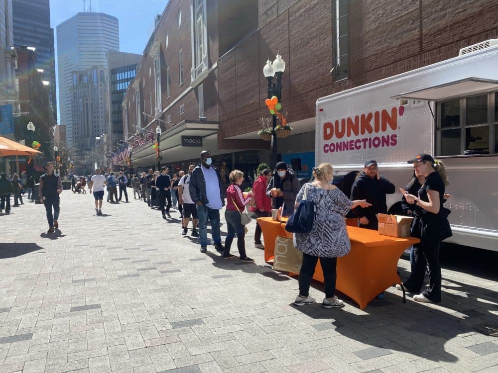 Downtown workers line up for free coffee, part of a city-supported program to lure remote workers back to their offices. (Walter Wuthmann/WBUR)