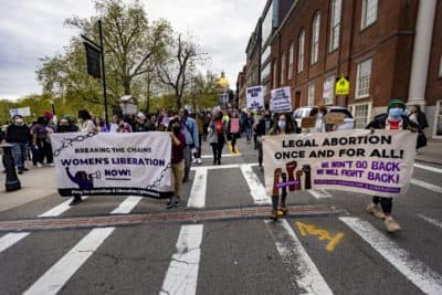 Protesters begin marching down Park Street during the Defend Abortion Rights rally at the Massachusetts State House. (Jesse Costa/WBUR)