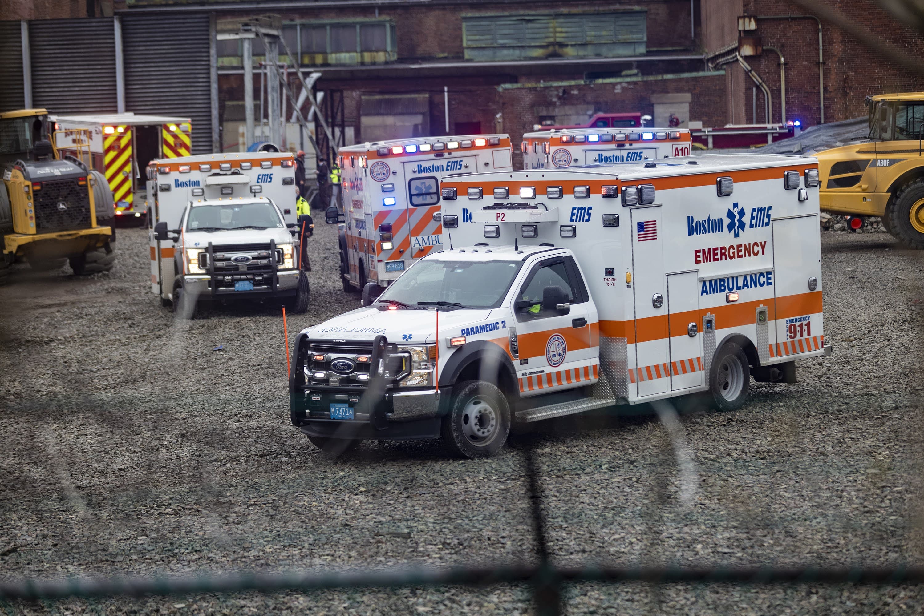 An ambulance leaves the scene with the worker who was trapped for several hours after a partial building collapse at the old Boston Edison power plant in South Boston. (Jesse Costa/WBUR)