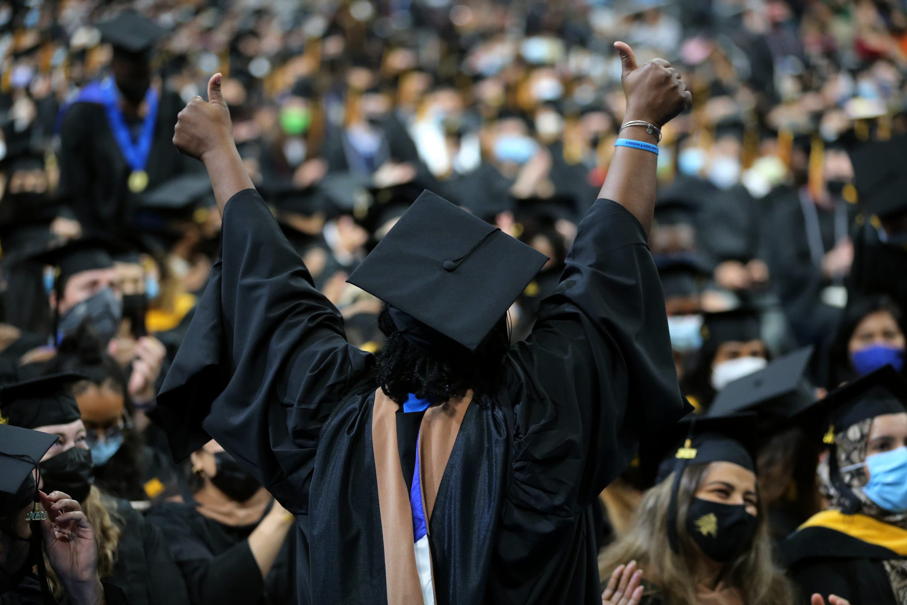 A student celebrates at the UMass Boston commencement ceremony at TD Garden in Boston in 2021. (Craig F. Walker/The Boston Globe via Getty Images)