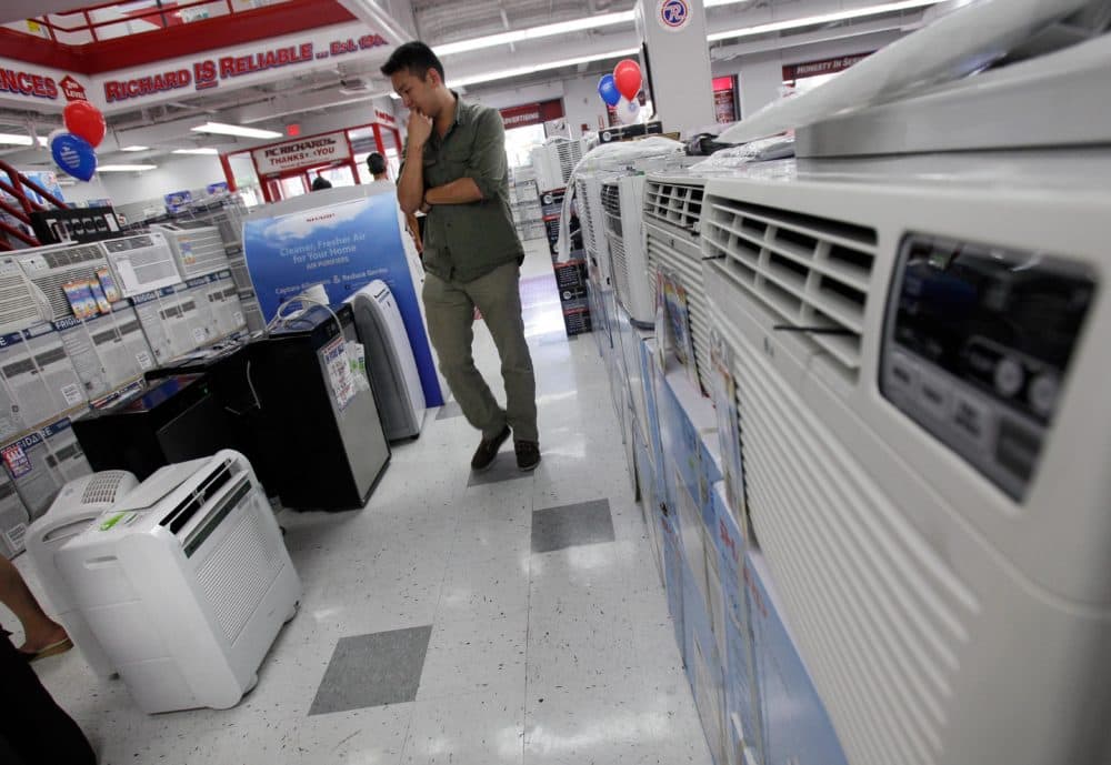 A man looks at air conditioners for sale at a P.C. Richard & Son store in New York. (Richard Drew/AP)