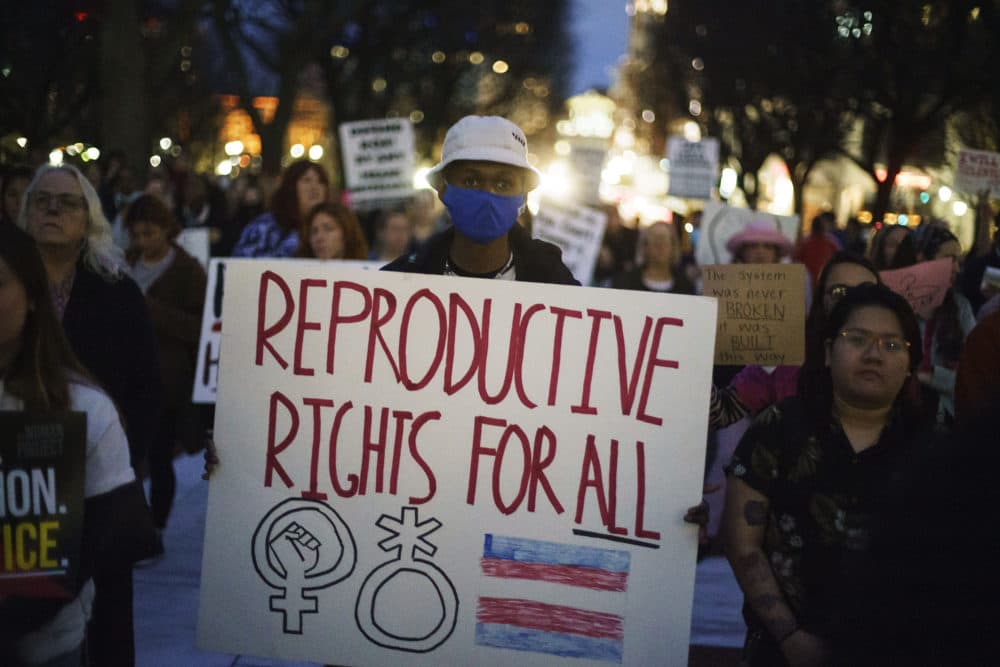 Tripp Hopkins, center, attends a rally to protest the news that the U.S. Supreme Court could be poised to overturn the landmark Roe v. Wade case that legalized abortion nationwide, Tuesday, May 3, 2022, at the Statehouse in Providence, R.I. (David Goldman/AP)