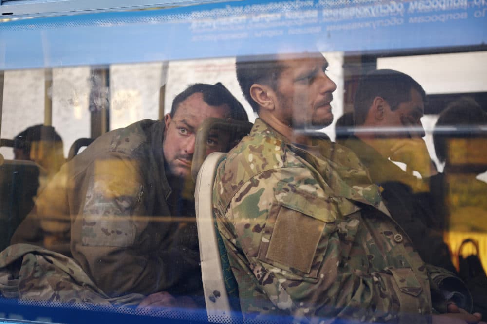 Ukrainian servicemen sit in a bus after they were evacuated from the besieged Mariupol's Azovstal steel plant, near a remand prison in Olyonivka, in territory under the government of the Donetsk People's Republic, eastern Ukraine, Tuesday, May 17, 2022. (Alexei Alexandrov/AP)
