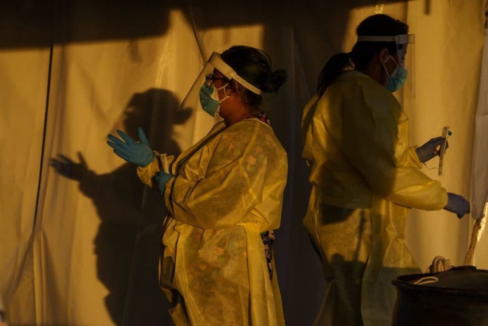 Healthcare workers are pictured at a drive-thru Covid-19 testing site in El Paso, Texas on January 12, 2022.  (Paul Ratje/AFP via Getty Images)