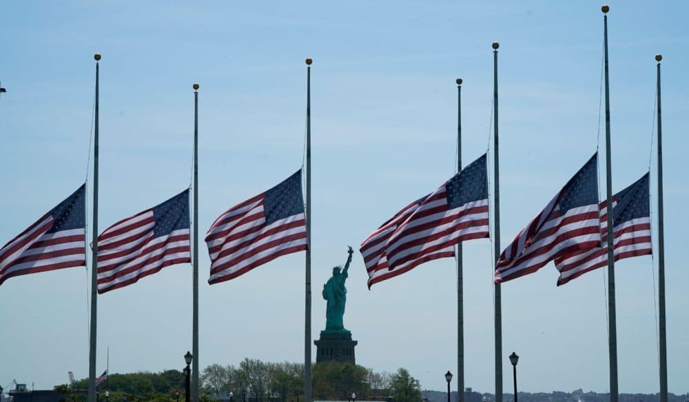 U.S. flags, across New York Bay from the Statue of Liberty, fly at half-mastat Liberty State Park in Jersey City, New Jersey, on May 25, 2022, as a mark of respect for the victims of the May 24 shooting at Robb Elementary School in Uvalde, Texas. (Timothy A. Clark/AFP via Getty Images)