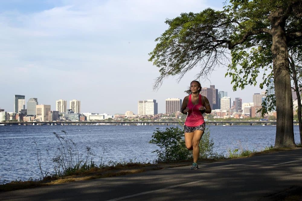 A runner out in the heat by the Charles River. (Robin Lubbock/WBUR)
