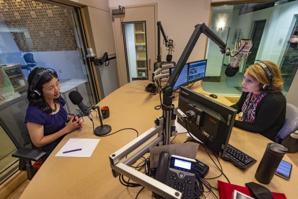 Mayor Michelle Wu speaking on the air with host Tiziana Dearing on Radio Boston. (Jesse Costa/WBUR)