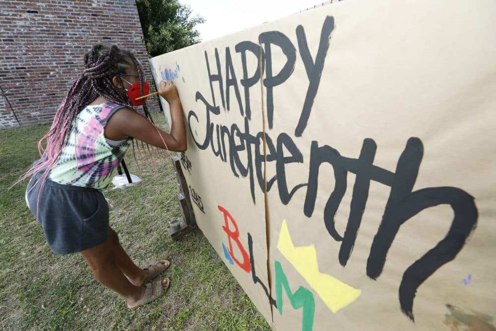 Amya Watson, 11, prints &quot;Black Power,&quot; on a poster celebrating Juneteenth during the &quot;Black Joy as Resistance! Juneteenth Celebration&quot; in the historic Farish Street business district in downtown Jackson, Miss., Friday, June 19, 2020. (Rogelio V. Solis/AP)