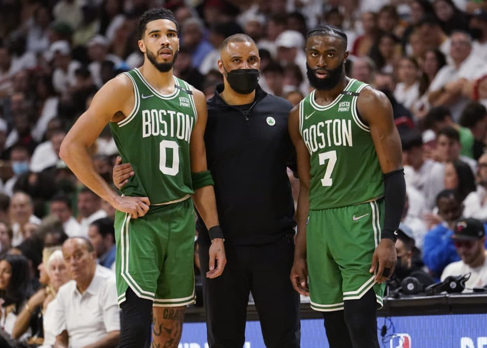 Boston Celtics head coach Ime Udoka speaks to Boston Celtics forward Jayson Tatum (0) and guard Jaylen Brown (7) during the second half of Game 1 of an NBA basketball Eastern Conference finals playoff series against the Miami Heat, Tuesday, May 17, 2022, in Miami. (Lynne Sladky/AP)