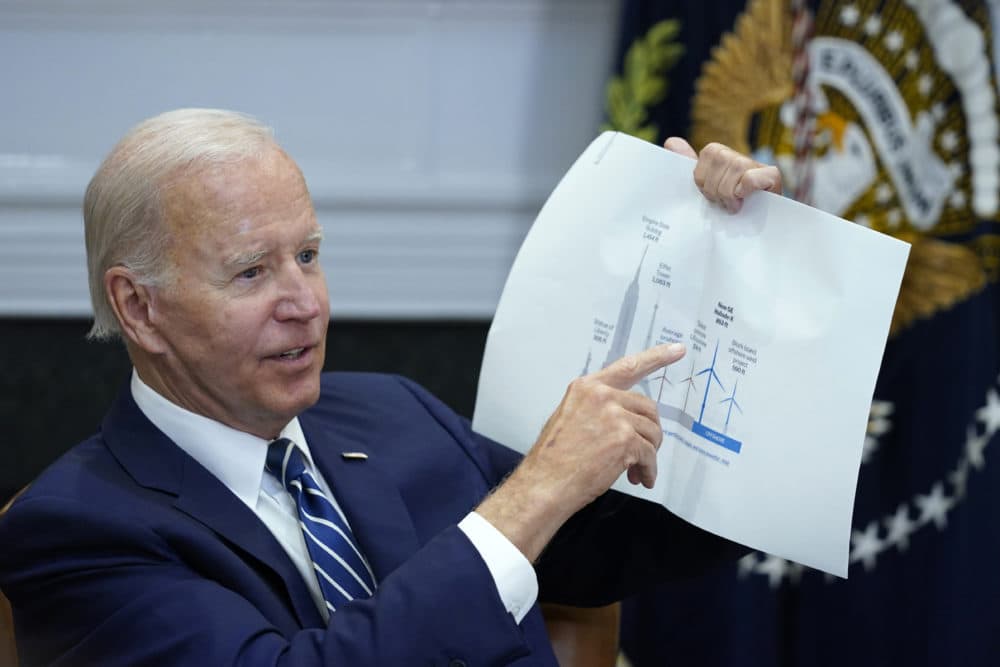 President Joe Biden shows a wind turbine size comparison chart during a meeting in the Roosevelt Room of the White House, June 23, 2022, with governors, labor leaders, and private companies launching the Federal-State Offshore Wind Implementation Partnership. (Susan Walsh/AP)