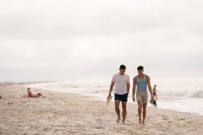 Conrad Ricamora and Joel Kim Booster in the film &quot;Fire Island,&quot; which screens at the 2022 Provincetown International Film Festival. (Courtesy Jeong Park/Searchlight Pictures)