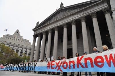 Climate activists protest on the fist day of the ExxonMobil trial outside the New York State Supreme Court building on October 22, 2019 in New York City. (Photo by Angela Weiss/AFP via Getty Images)
