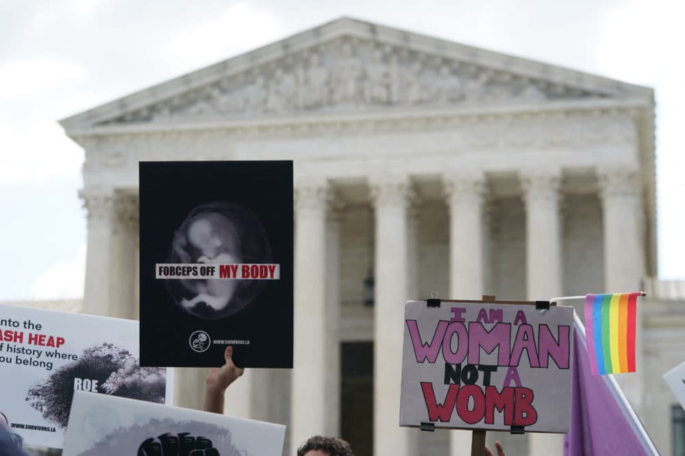Pro-choice and pro-life signs are seen outside the U.S. Supreme Court in Washington, DC, on June 24, 2022. (Olivier Douliery/AFP via Getty Images)