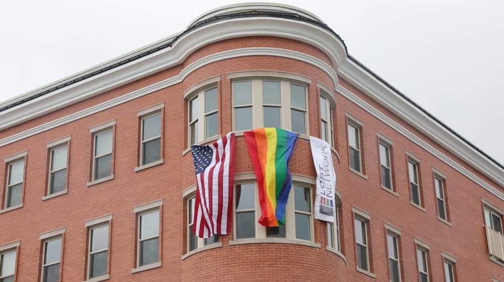 Flags fly from the top story of a new affordable housing complex for LGBT senior citizens constructed in Bay Shore, New York on Long Island on Sept. 17, 2021. A similar development is in the works in Boston. (Photo by Reese T. Williams/Newsday RM via Getty Images)