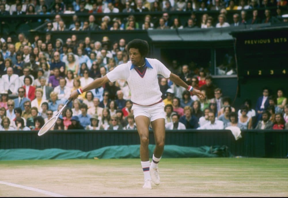 Arthur Ashe runs for the ball during a match at Wimbledon in England. (Photo by Tony Duffy/Getty Images)