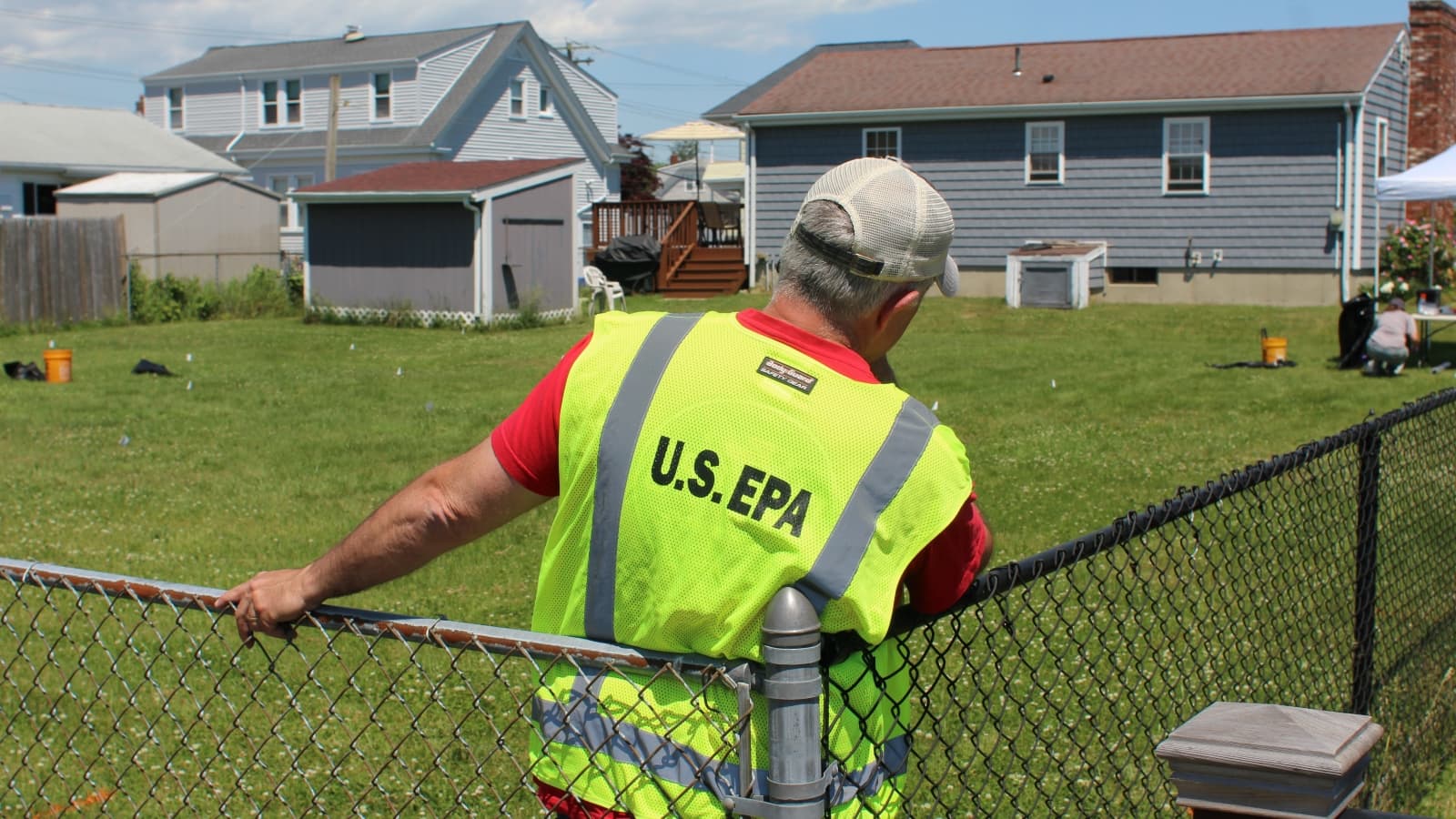 EPA crews begin work in the backyard of a single-family home in Dartmouth on Monday. (Ben Berke/The Public's Radio)
