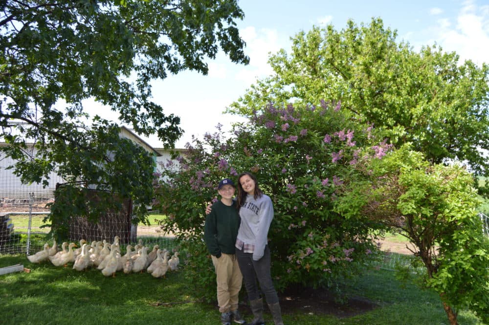 Shae Pesek (left) and Anna Hankins (right) own and operate Over the Moon Farm and Flowers in Coggon, Iowa. “We’ve had a lot of support, honestly, especially from our very local community. There’s a lot of people that will tell us like, ’Oh, I showed my queer relative your page, and they were really excited to know that you existed,’” Pesek said. (Catherine Wheeler/Iowa Public Radio and Harvest Public Media)