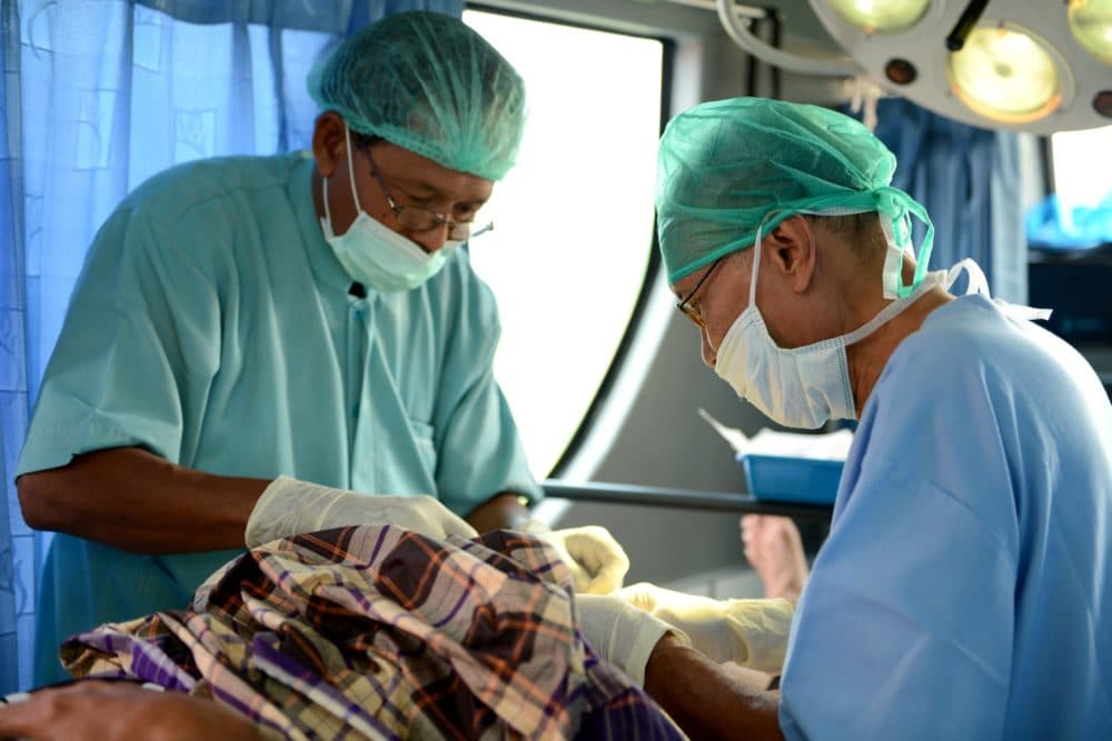 Doctors perform a vasectomy. (Sonny Tumbelaka/AFP via Getty Images)
