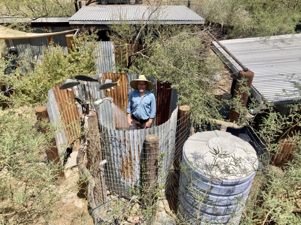Brad Lancaster in an outdoor shower that uses water collected from the rain. The Tucson resident has written a book about harvesting rainwater. (Peter O'Dowd/ Here & Now)