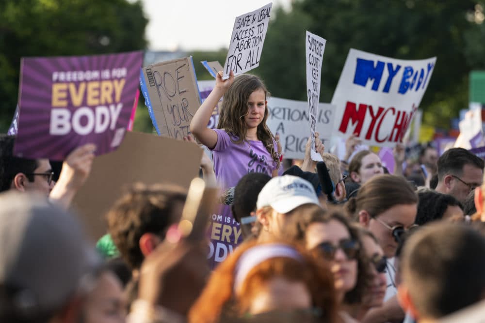 A girls holds a sign in support of abortion rights following the Supreme Court's decision to overturn Roe v. Wade in Washington, Friday, June 24, 2022. (AP Photo/Jacquelyn Martin)