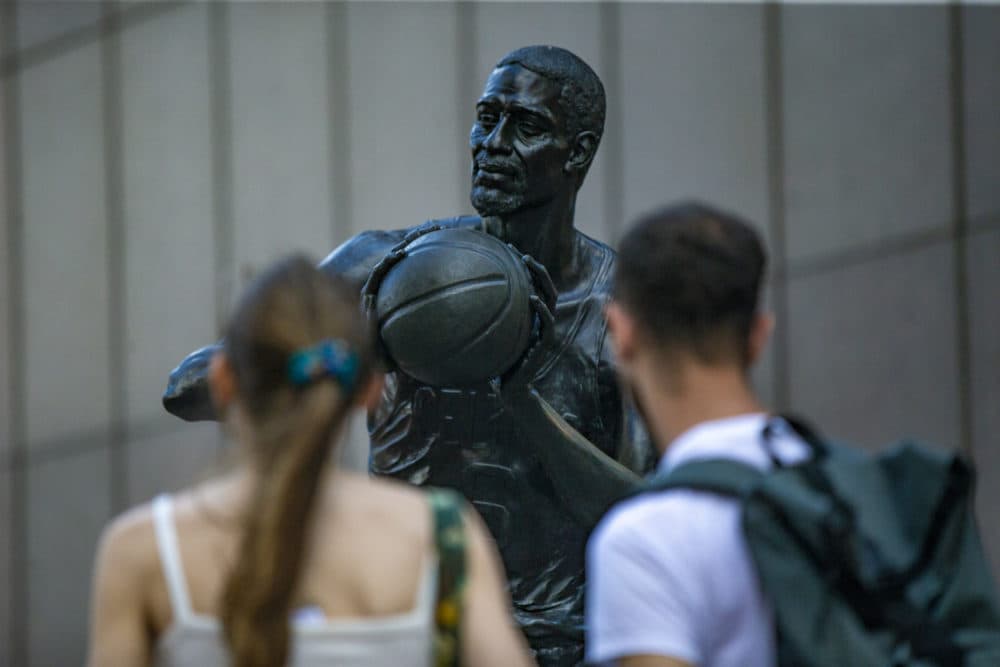 Fans pay their respects to Bill Russell at a statue of him at Boston's City Hall Plaza. (Jesse Costa/WBUR)