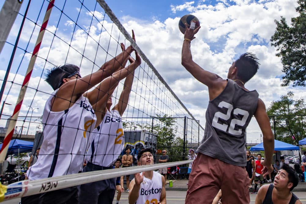 A player on the Boston Rising Tide attempts to spike the ball against the Hurricanes at Reggie Wong Memorial Park in Chinatown. (Jesse Costa/WBUR)