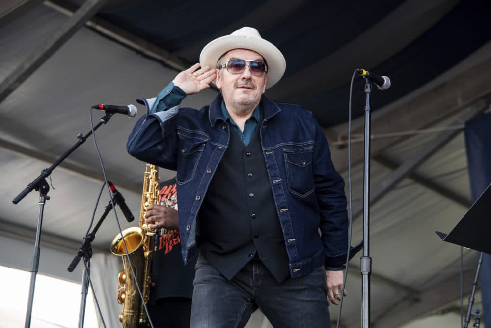 Elvis Costello performs with the Dirty Dozen Brass Band at the New Orleans Jazz and Heritage Festival, on Thursday, May 5, 2022, in New Orleans. (Photo by Amy Harris/Invision/AP)