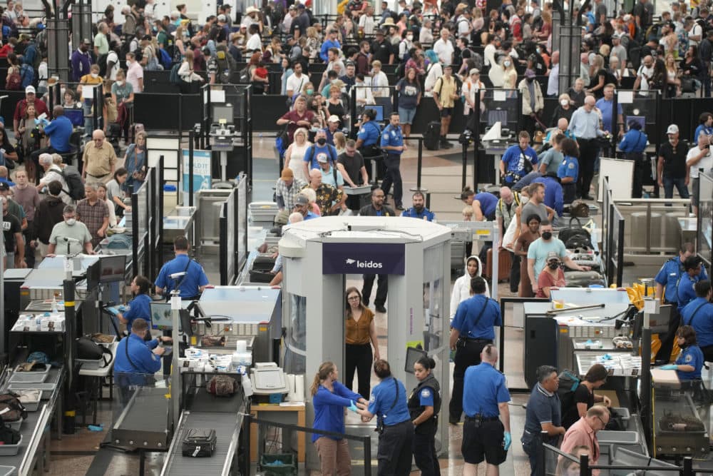 Travelers queue up at the south security checkpoint in Denver International Airport. (David Zalubowski/AP)