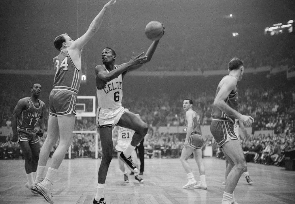 Boston Celtics' player Bill Russell hooks a shot during the NBA championship's final game in 1960 against the Saint Louis Hawks. (Getty Images)